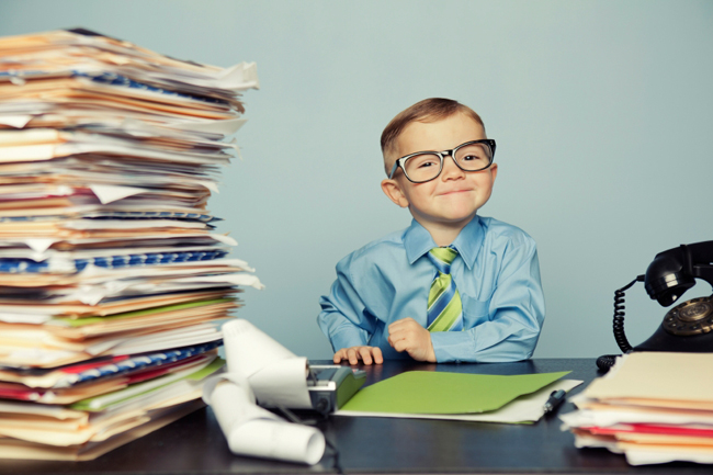 Child in a suit pretending to be an accountant 